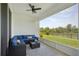 Screened-in patio with a seating area and a view of the backyard at 5411 Thistle Field Ct, Wesley Chapel, FL 33545