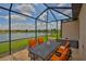 Screened lanai features beautiful lake views and a table with seating perfect for enjoying the outdoors at 5532 Sunset Falls Dr, Apollo Beach, FL 33572