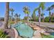 Water feature at community entrance features rocks, tropical plants, and palm trees at 5532 Sunset Falls Dr, Apollo Beach, FL 33572