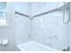 Modern bathroom features beautiful marble tiling, and a convenient corner shelf for toiletries at 6004 S 82Nd St, Tampa, FL 33619