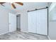 Bright bedroom features light wood flooring and a closet with stylish sliding doors at 6004 S 82Nd St, Tampa, FL 33619