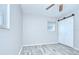 Spacious bedroom features light wood flooring, a ceiling fan, and a closet with sliding doors at 6004 S 82Nd St, Tampa, FL 33619