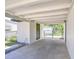 Spacious carport area with a covered area, an enclosed storage room, and a gated entrance at 6004 S 82Nd St, Tampa, FL 33619