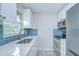 Modern kitchen with stainless steel appliances, white cabinets, and blue backsplash at 6004 S 82Nd St, Tampa, FL 33619