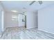 Inviting living room with wood-look flooring, neutral walls, with a view of the kitchen and backyard at 6004 S 82Nd St, Tampa, FL 33619