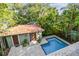 A picturesque aerial view of the backyard pool and patio with a lush tropical backdrop at 6008 Interbay Blvd, Tampa, FL 33611