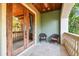 A charming balcony with seating offers a serene outdoor space with views of tropical foliage at 6008 Interbay Blvd, Tampa, FL 33611