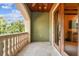 Inviting balcony featuring a stone balustrade, wood ceiling and lush scenery visible through the opening at 6008 Interbay Blvd, Tampa, FL 33611