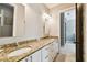 Bright bathroom with granite counters, double sinks, and white cabinets at 6008 Interbay Blvd, Tampa, FL 33611