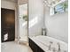 Bright bathroom features a soaking tub, glass shower, and modern fixtures, creating a relaxing retreat at 6008 Interbay Blvd, Tampa, FL 33611