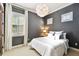 Cozy bedroom with white bedding, gray walls, and light-filtering shutters on the windows at 6008 Interbay Blvd, Tampa, FL 33611