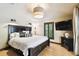 This bedroom features a large window with shutters and lots of natural light at 6008 Interbay Blvd, Tampa, FL 33611