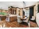 Elegant dining room featuring wood floors, a wooden table, and unique pendant lighting at 6008 Interbay Blvd, Tampa, FL 33611
