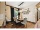 Dining room featuring wood floors, a wooden table and chairs, and decorative lighting fixture at 6008 Interbay Blvd, Tampa, FL 33611