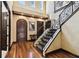 Elegant foyer boasts hardwood floors, an iron staircase, and arched doorways at 6008 Interbay Blvd, Tampa, FL 33611