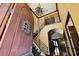 Grand foyer with soaring ceilings, wrought iron staircase, chandelier, and hardwood floors at 6008 Interbay Blvd, Tampa, FL 33611