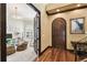 Elegant foyer showcasing a dark wood door, hardwood floors and an open doorway to a playroom at 6008 Interbay Blvd, Tampa, FL 33611
