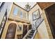 Elegant foyer boasting hardwood floors, an iron staircase, soaring ceilings and arched doorways at 6008 Interbay Blvd, Tampa, FL 33611