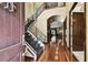Grand foyer with soaring ceilings, wrought iron staircase, chandelier, and hardwood floors at 6008 Interbay Blvd, Tampa, FL 33611