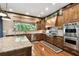 Open kitchen features custom cabinetry, granite countertops, and stainless steel appliances at 6008 Interbay Blvd, Tampa, FL 33611