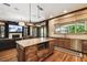 Open-concept kitchen featuring granite counters and an island with seating flowing into the living space at 6008 Interbay Blvd, Tampa, FL 33611