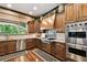 Gourmet kitchen featuring an island cooktop with modern stainless steel appliances and custom wood cabinetry at 6008 Interbay Blvd, Tampa, FL 33611