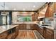 This kitchen features custom wood cabinetry, granite counters, and modern stainless steel appliances at 6008 Interbay Blvd, Tampa, FL 33611