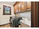 A laundry room featuring a washer, dryer, storage cabinets, window and a utility sink at 6008 Interbay Blvd, Tampa, FL 33611