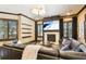 Bright living room with fireplace, hardwood floors, large windows, and comfortable sectional sofa at 6008 Interbay Blvd, Tampa, FL 33611