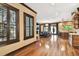 Open-concept living space with wood floors, plantation shutters, and kitchen and living areas at 6008 Interbay Blvd, Tampa, FL 33611