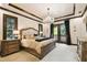 Elegant bedroom features a chandelier, wooden trim, and balcony access, creating a luxurious retreat at 6008 Interbay Blvd, Tampa, FL 33611
