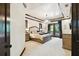 Bright main bedroom featuring a bed, chandelier, and balcony doors at 6008 Interbay Blvd, Tampa, FL 33611