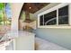 This outdoor kitchen features a stainless steel grill, backsplash, and a spacious countertop for entertaining at 6008 Interbay Blvd, Tampa, FL 33611