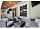Covered back patio with seating, tv, grill, wood ceiling and exterior window at 6008 Interbay Blvd, Tampa, FL 33611