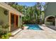 Backyard view with a pool and tropical landscaping and partial home view at 6008 Interbay Blvd, Tampa, FL 33611