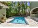 A stunning rectangular swimming pool surrounded by lush greenery, perfect for cooling off on a hot day at 6008 Interbay Blvd, Tampa, FL 33611
