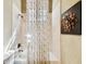Bathroom shower and tub featuring decorative floral art and a neutral-toned shower curtain at 6008 Interbay Blvd, Tampa, FL 33611