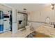Bathroom featuring double vanity, walk-in shower, and an organized walk-in closet at 6265 Sun Blvd # 1203, St Petersburg, FL 33715