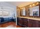 Bathroom boasts double sink vanity and marble accent wall with a view to the bedroom at 6265 Sun Blvd # 1203, St Petersburg, FL 33715