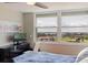 Bedroom featuring water view from large window and built-in workspace at 6265 Sun Blvd # 1203, St Petersburg, FL 33715