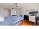 Bedroom featuring hardwood floors, a large TV, and natural light from nearby windows at 6265 Sun Blvd # 1203, St Petersburg, FL 33715