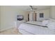 Modern bedroom with a white comforter, ceiling fan, and views to the hall at 6265 Sun Blvd # 1203, St Petersburg, FL 33715