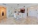 Dining room area featuring travertine floors and views into the kitchen at 6265 Sun Blvd # 1203, St Petersburg, FL 33715