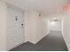 Condo hallway with gray carpet and a white door with unit number at 6265 Sun Blvd # 1203, St Petersburg, FL 33715