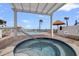 Inviting hot tub area overlooks a pool and a waterfront with clear sky beyond at 6265 Sun Blvd # 1203, St Petersburg, FL 33715