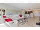 Open-concept living room with tile floors, modern furniture, and a view of the kitchen, creating an inviting atmosphere at 6265 Sun Blvd # 1203, St Petersburg, FL 33715