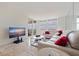 Bright living room with travertine floors, large windows, and views of the balcony at 6265 Sun Blvd # 1203, St Petersburg, FL 33715
