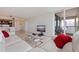 Open living area with travertine floors, kitchen access, and sliding glass doors to the balcony at 6265 Sun Blvd # 1203, St Petersburg, FL 33715