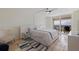 Bright bedroom with a modern bed, stylish decor, and access to a balcony, creating a serene and comfortable retreat at 6265 Sun Blvd # 1203, St Petersburg, FL 33715