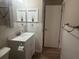 White vanity with white counter and chrome faucet complimented by board and batten wall accents at 6520 Thicket Trl, New Port Richey, FL 34653